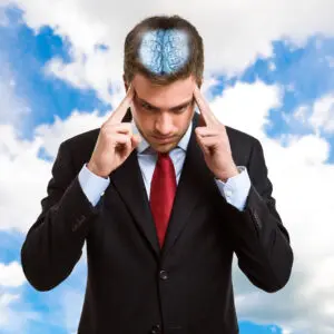 A man in a suit and tie with his head in the clouds.