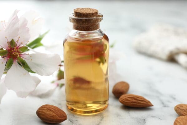 A bottle of almond oil sitting on top of a table.