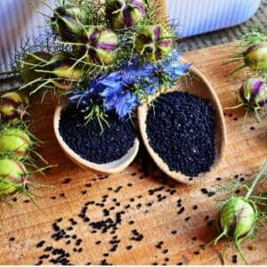 A bowl of black rice and some green beans