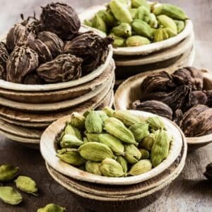 A wooden table topped with bowls of nuts.