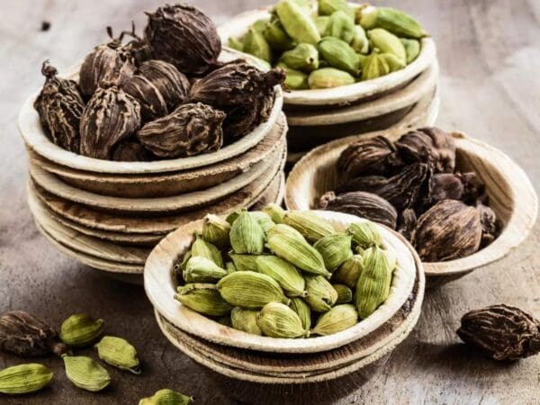 A wooden table topped with bowls of nuts.