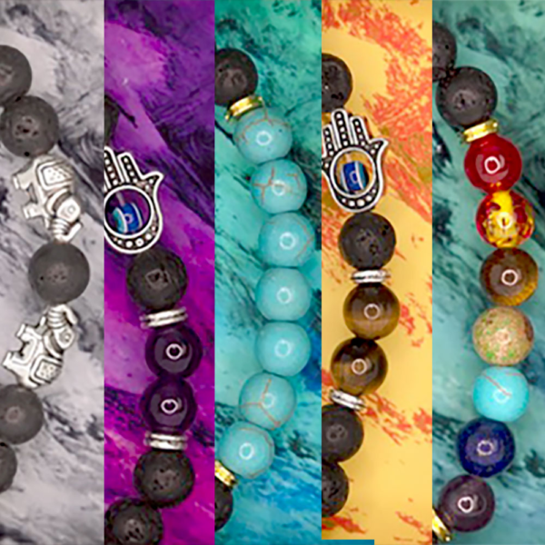 A series of different colored bracelets with hamsa charms.