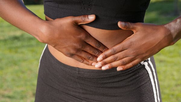 A person holding their stomach in front of her belly.