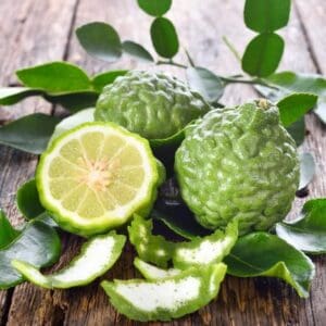 A wooden table with some green fruit on it