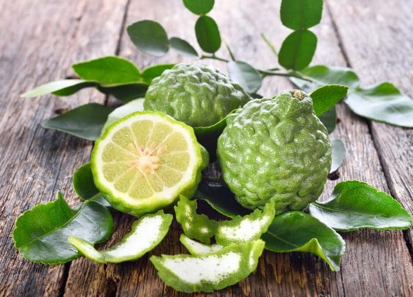 A wooden table with some green fruit on it