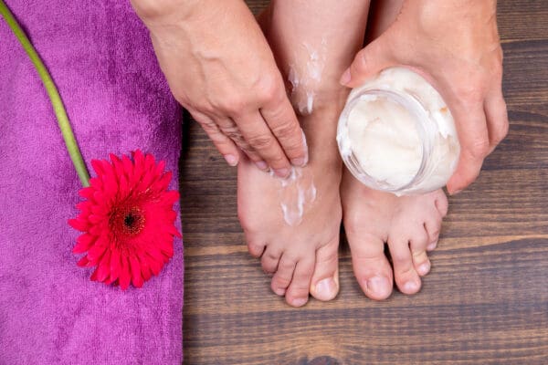 A person is getting their feet waxed