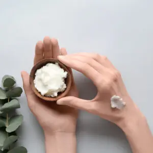 A person holding a bowl of whipped cream