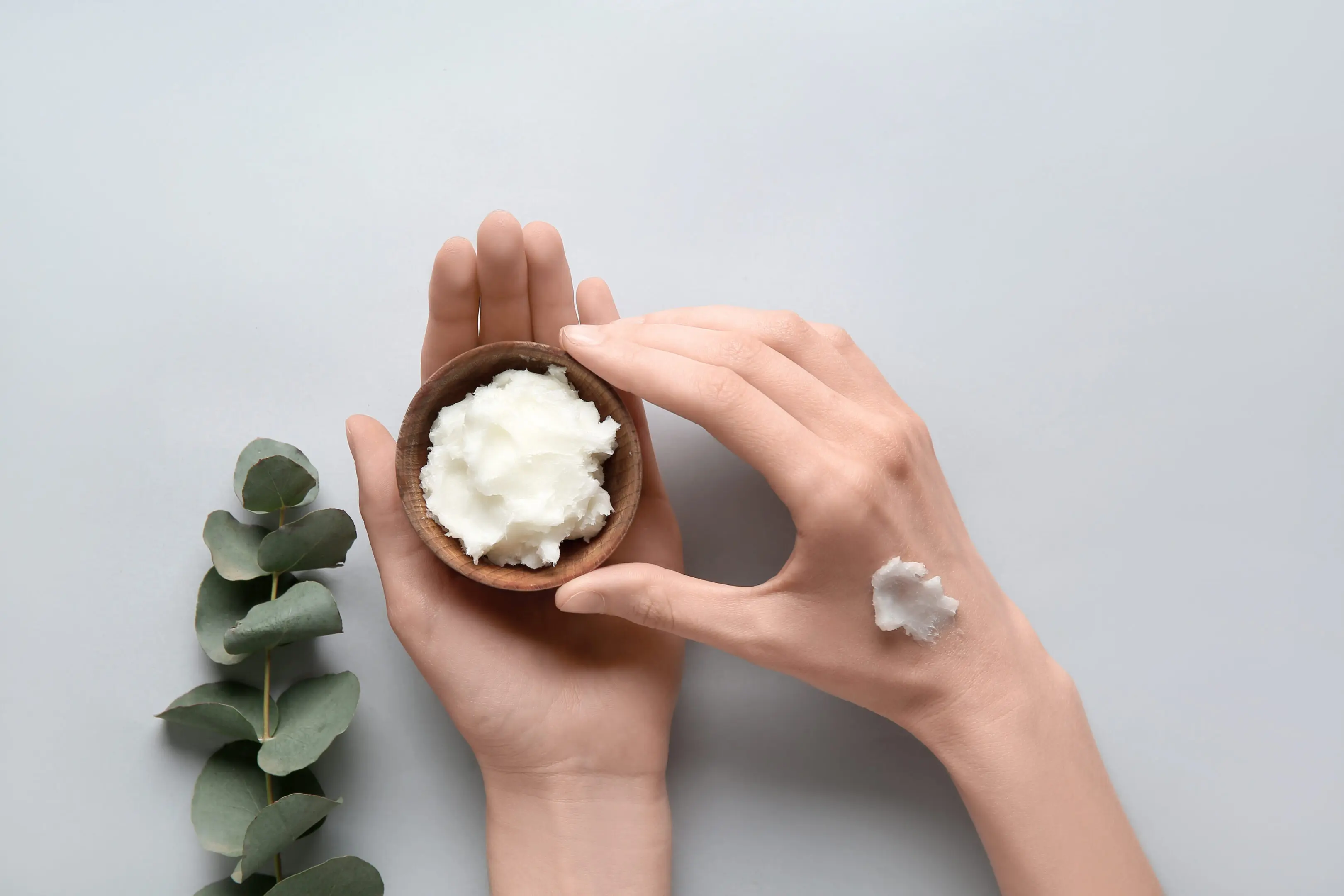 A person holding a bowl of whipped cream