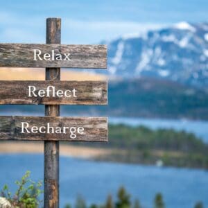 A wooden sign with the words " reb 's reflect recharge ".