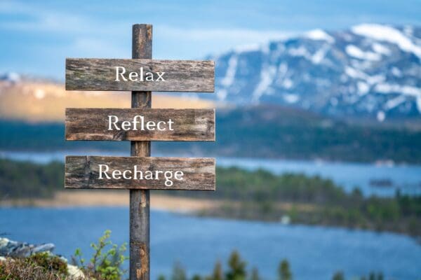 A wooden sign with the words " reb 's reflect recharge ".