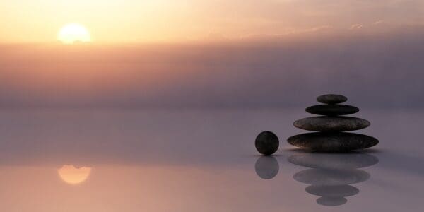 A stack of rocks on top of the water.